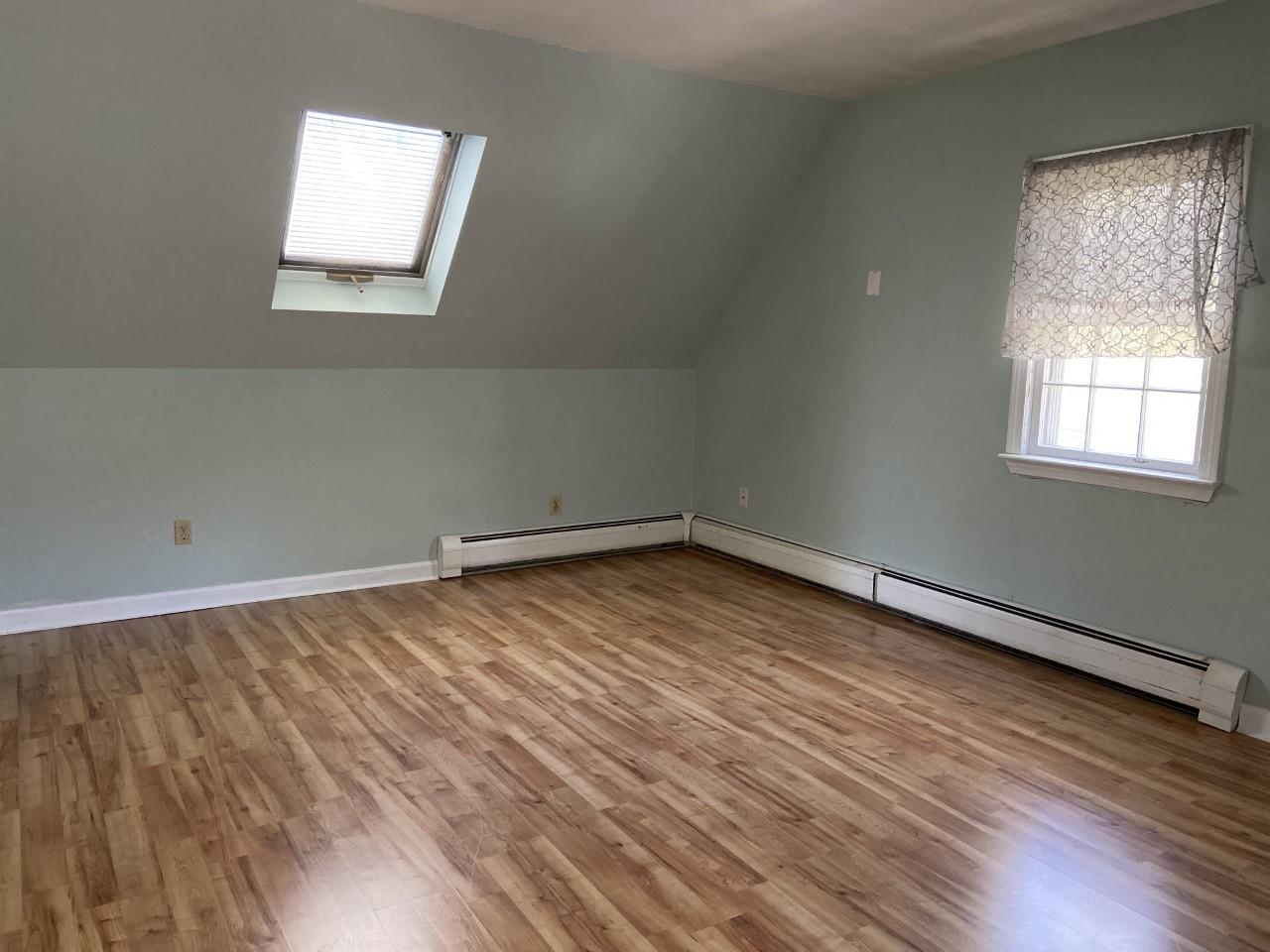 170 Taramac Road Centerville, MA 02632 - Photo 14 of 20 an empty room with wooden floor and windows