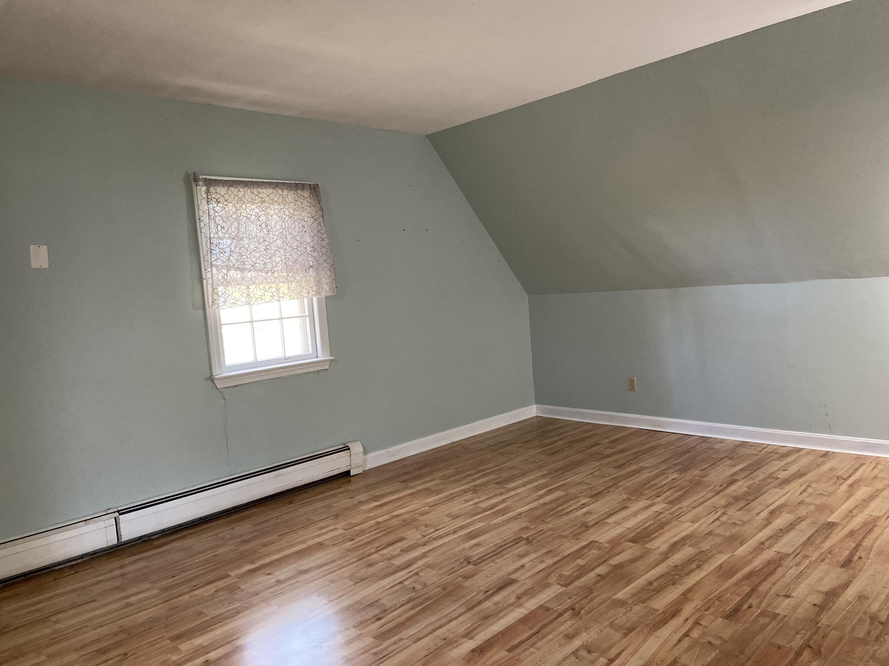 170 Taramac Road Centerville, MA 02632 - Photo 15 of 20 a view of an empty room with wooden floor and a window