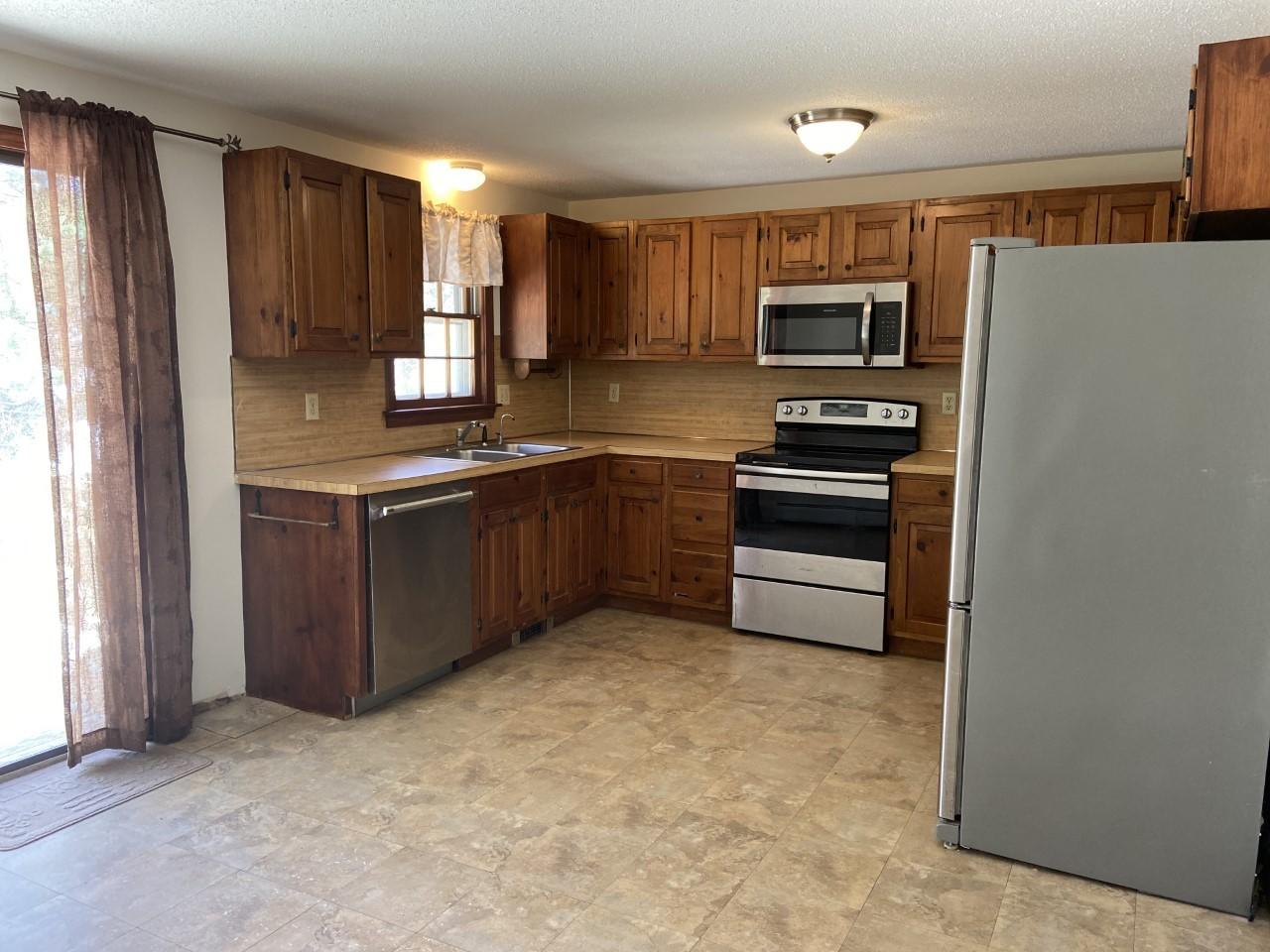 170 Taramac Road Centerville, MA 02632 - Photo 16 of 20 a kitchen with stainless steel appliances granite countertop a refrigerator and a stove top oven