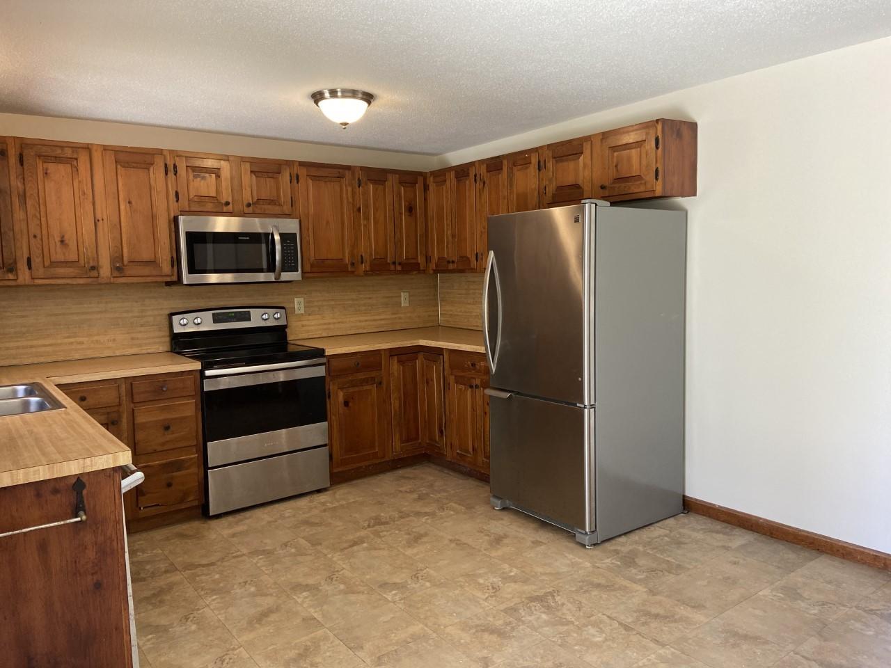 170 Taramac Road Centerville, MA 02632 - Photo 17 of 20 a kitchen with a refrigerator stove and microwave