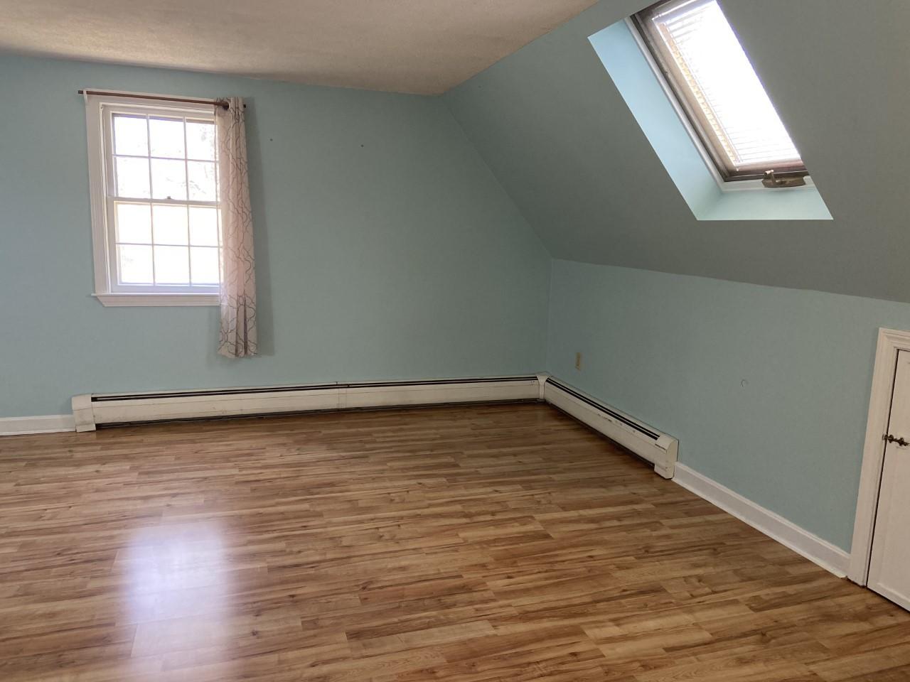 170 Taramac Road Centerville, MA 02632 - Photo 9 of 20 an empty room with wooden floor and windows
