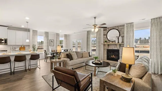 a living room with furniture a mirror and a fireplace