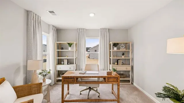 a bedroom with a bed a lamp and a dresser