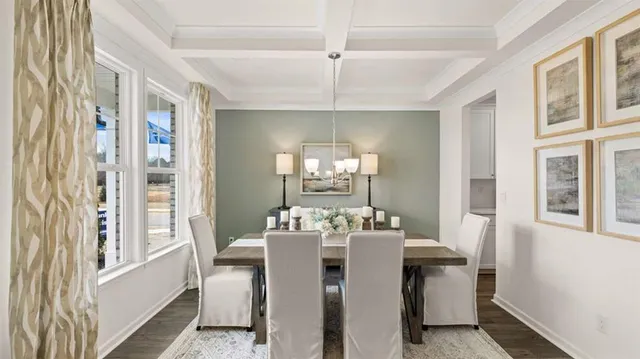 a kitchen with stainless steel appliances kitchen island granite countertop a dining table chairs refrigerator and sink