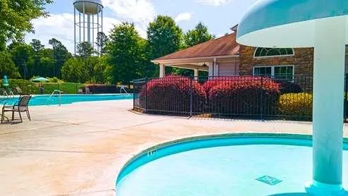 a view of an outdoor space with swimming pool and trees