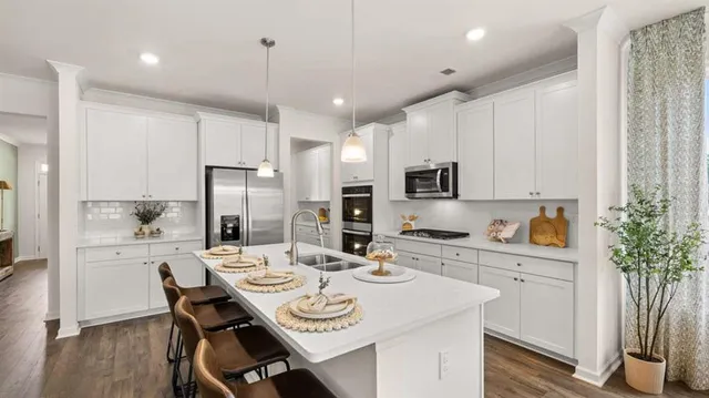 a kitchen with a sink appliances and a refrigerator