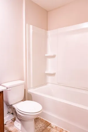a bathroom with a toilet and a bathtub