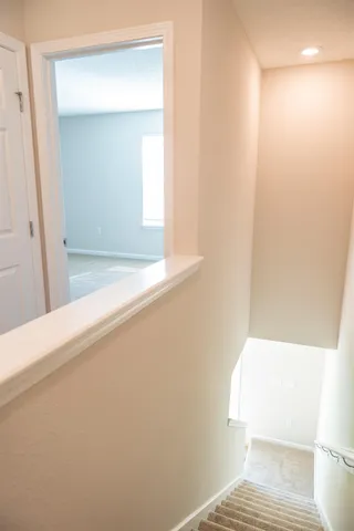 a view of a house with a yard and large tree