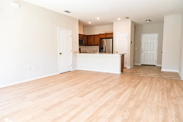 a big room with wooden floor and windows