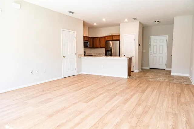 a big room with wooden floor and windows