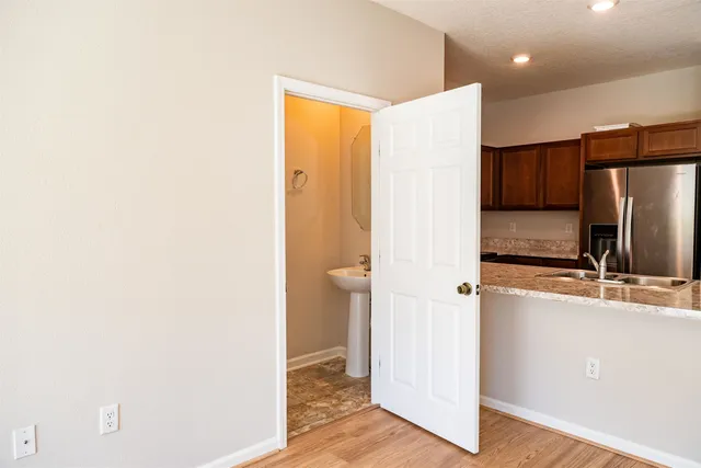 a room with a refrigerator and a dresser