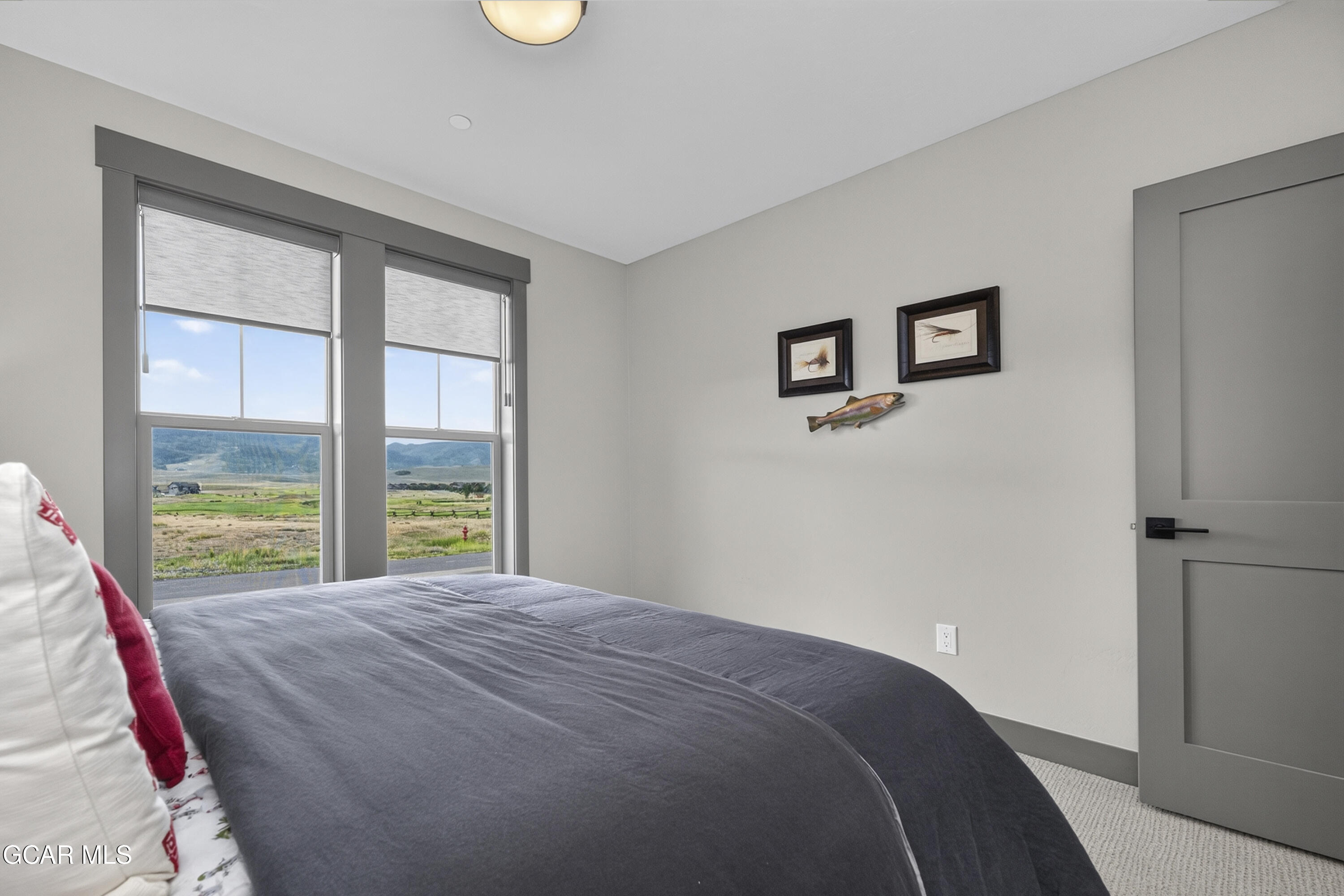 154 Eagle Ridge Drive Granby, CO 80446 - Photo 8 of 59 a bedroom with a bed and a large window