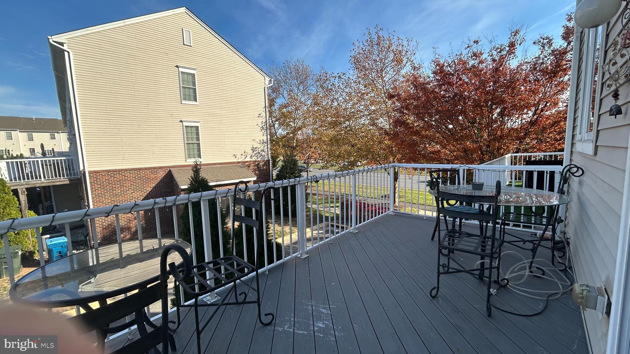 42828 Nations Street Chantilly, VA 20152 - Photo 19 of 19 a view of a roof deck with table and chairs with wooden floor and fence