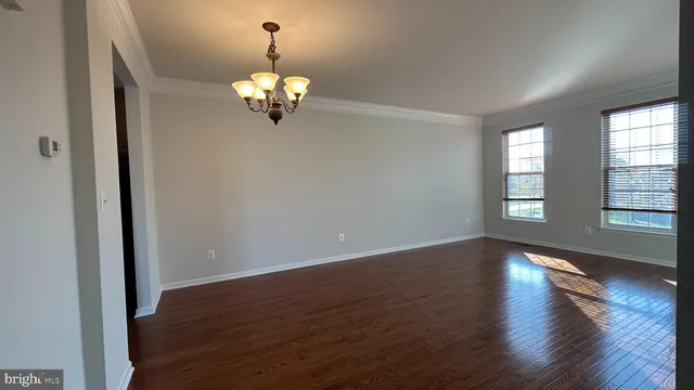 a view of wooden floor and chandelier in a room