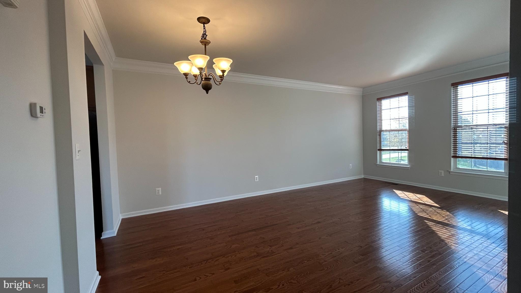42828 Nations Street Chantilly, VA 20152 - Photo 3 of 19 a view of wooden floor and chandelier in a room