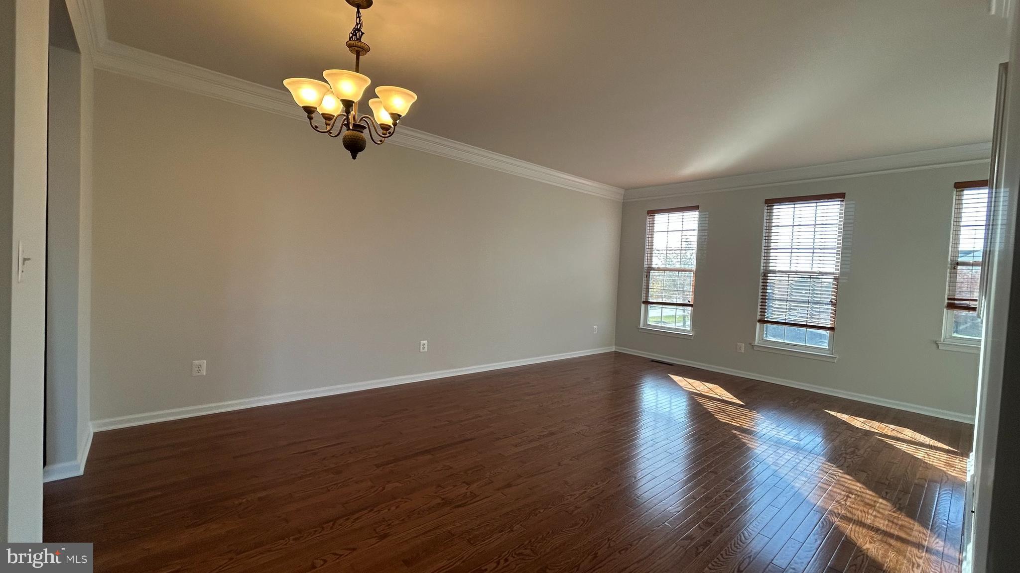 42828 Nations Street Chantilly, VA 20152 - Photo 5 of 19 a view of an empty room with wooden floor and a window