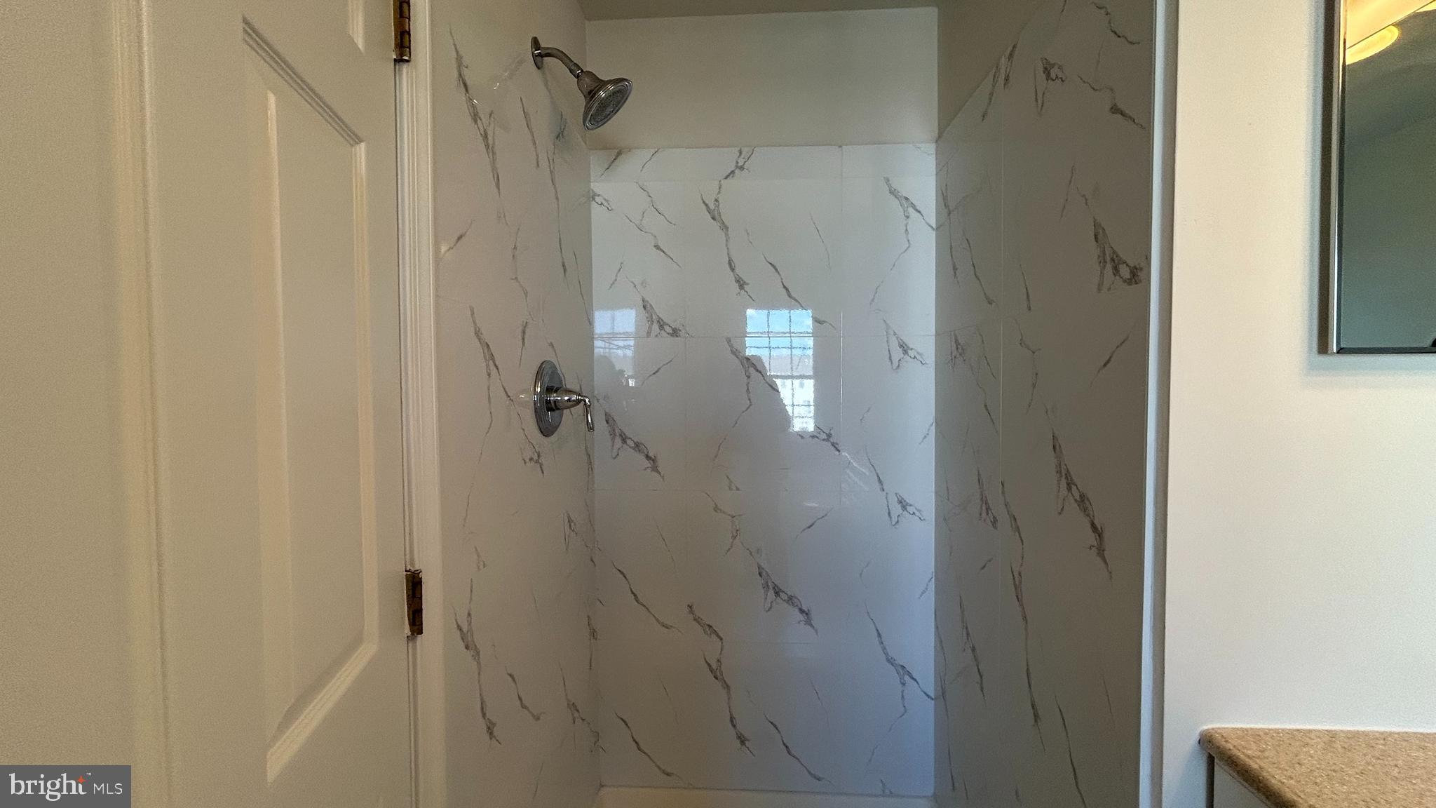 42828 Nations Street Chantilly, VA 20152 - Photo 10 of 19 a bathroom with a glass shower door