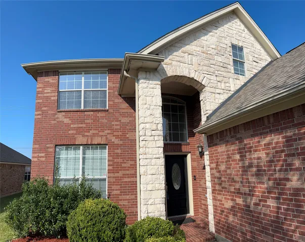 a front view of a house with large windows