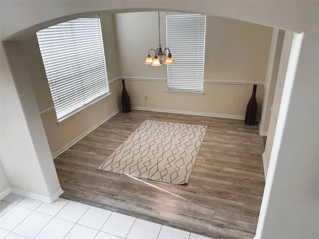 a view of wooden floor and windows in a room