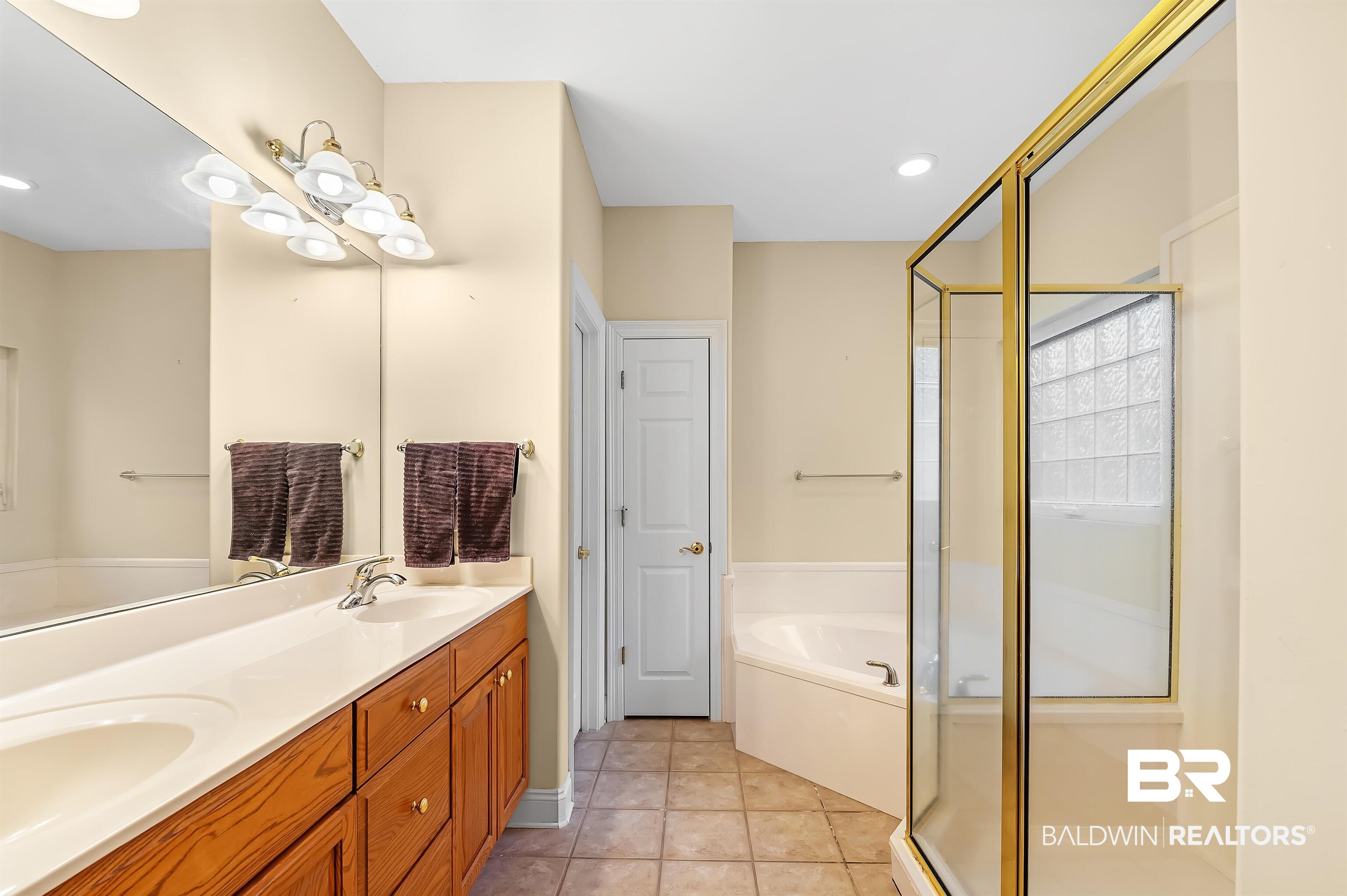 22726 Inverness Way Foley, AL 36535 - Photo 36 of 51 Bathroom with tile patterned floors, vanity, and separate shower and tub
