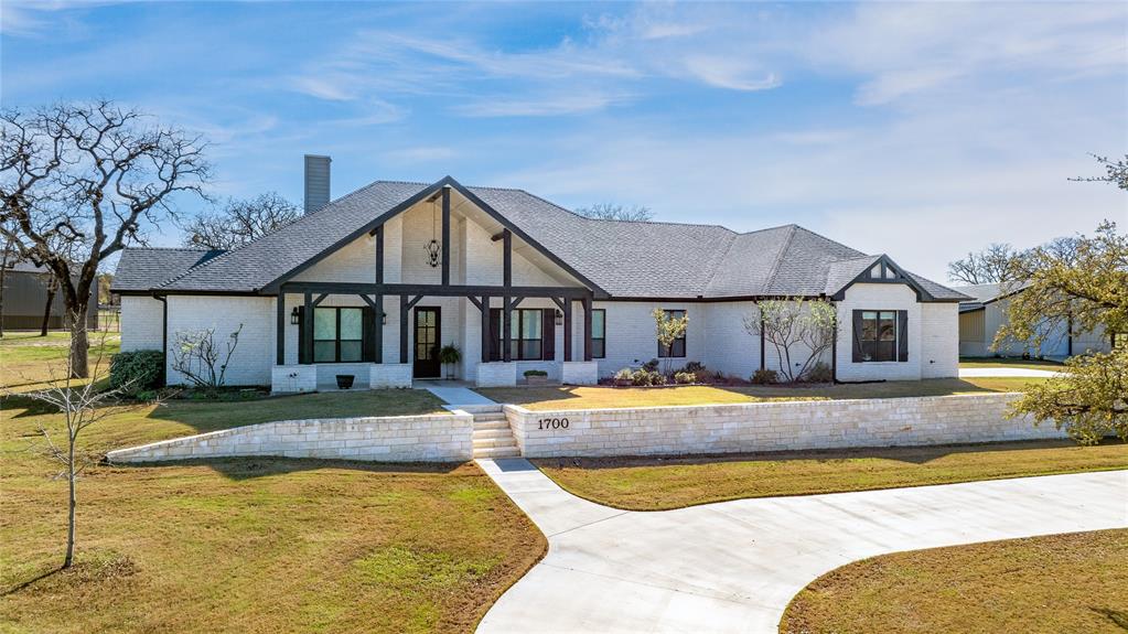 a view of a house with swimming pool and sitting area