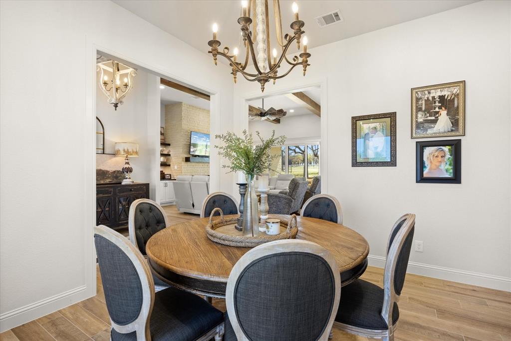 1700 Knox Road Tolar, TX 76476 - Photo 14 of 39 a view of a dining room with furniture wooden floor and chandelier