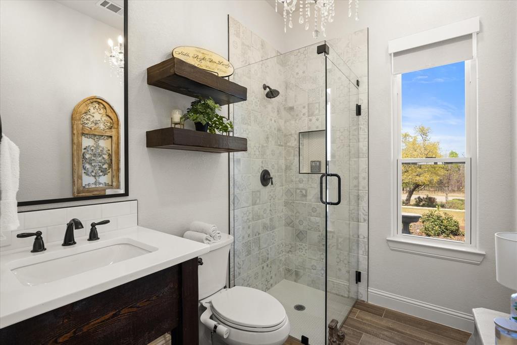 1700 Knox Road Tolar, TX 76476 - Photo 15 of 39 a bathroom with a granite countertop sink a toilet and shower