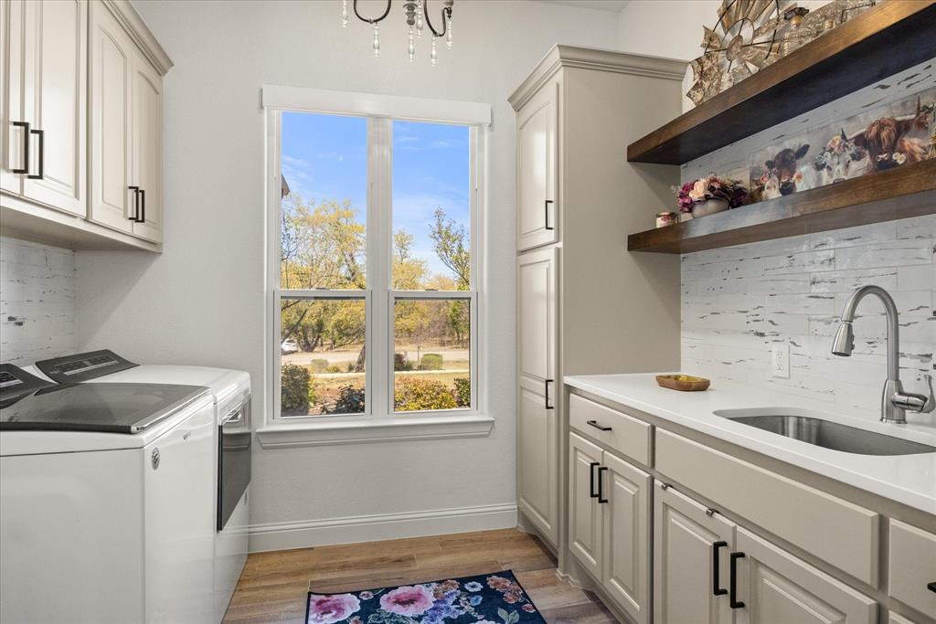 1700 Knox Road Tolar, TX 76476 - Photo 16 of 39 a utility room with cabinets washer and dryer