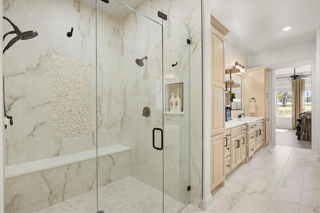 1700 Knox Road Tolar, TX 76476 - Photo 21 of 39 a bathroom with a shower sink and mirror
