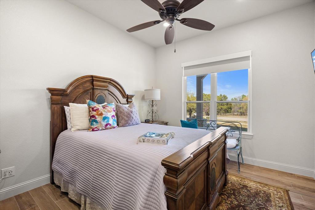 1700 Knox Road Tolar, TX 76476 - Photo 26 of 39 a bedroom with a bed and a table in it