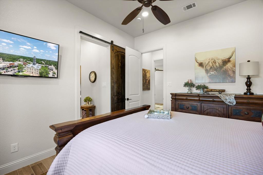 1700 Knox Road Tolar, TX 76476 - Photo 27 of 39 a bedroom with a bed and a flat screen tv