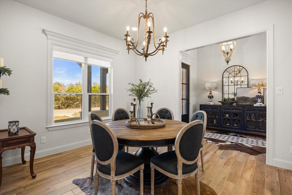 1700 Knox Road Tolar, TX 76476 - Photo 6 of 39 a view of a dining room with furniture wooden floor and chandelier