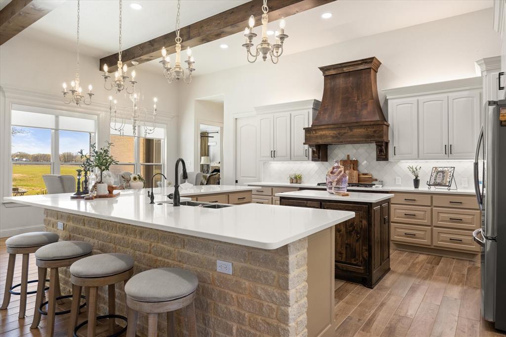 1700 Knox Road Tolar, TX 76476 - Photo 7 of 39 a kitchen with a stove a sink and a refrigerator