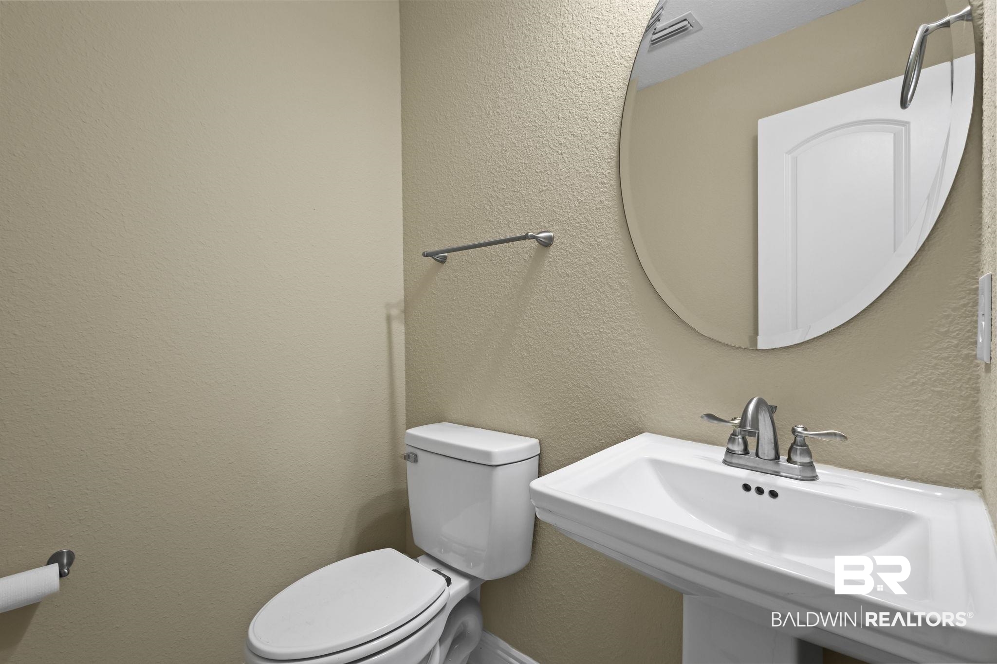 8781 Baptist Camp Road Elberta, AL 36530 - Photo 22 of 44 Half bathroom with visible vents, a textured wall, a sink, and toilet