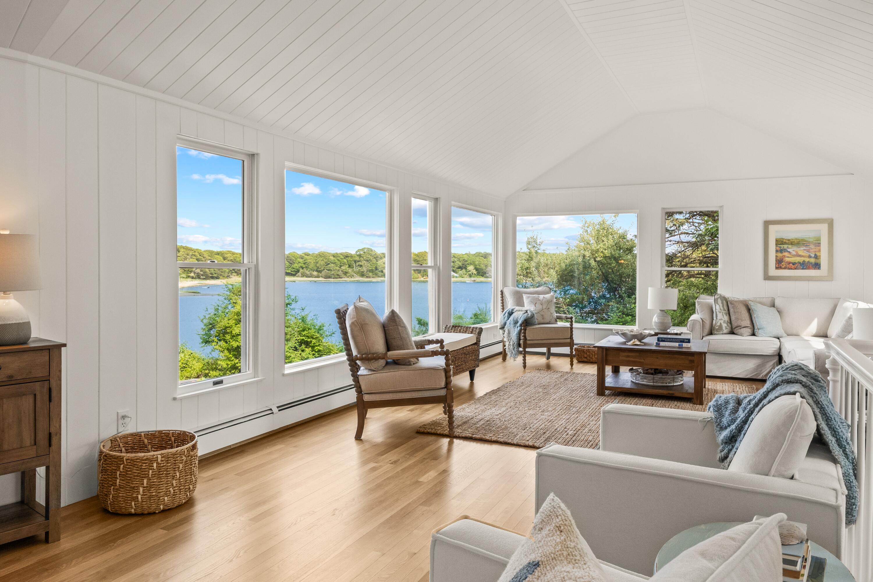 a living room with furniture and large windows