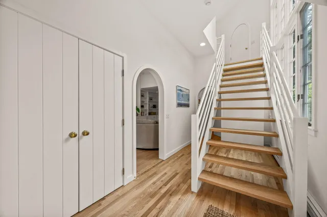 a spacious bedroom with a large bed and large windows