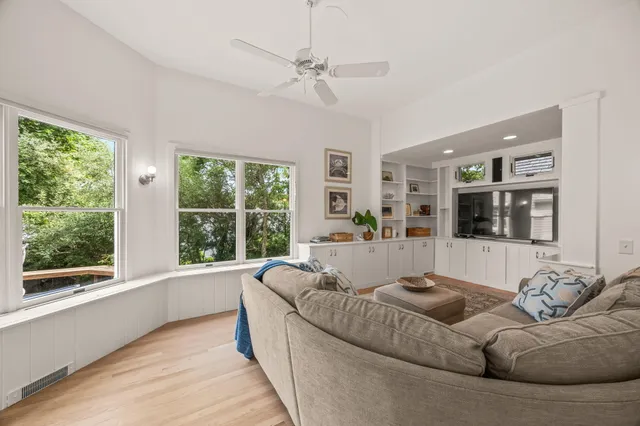 a picture of a rug in a white house next to a white wall