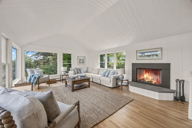 a bedroom with a bed a large window and a table