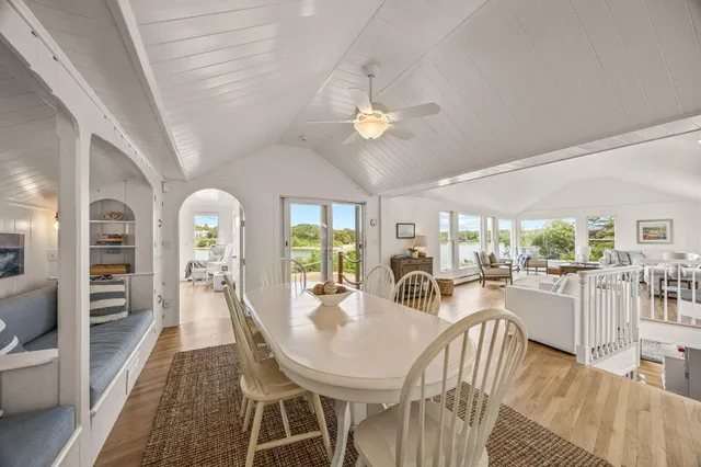 a bed sitting in a spacious bedroom next to a large window