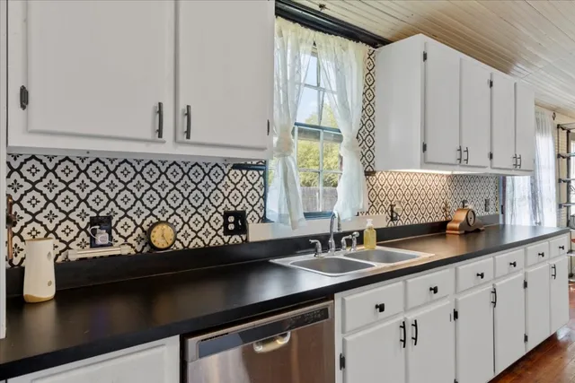 a kitchen with lot of counter space and wooden floor