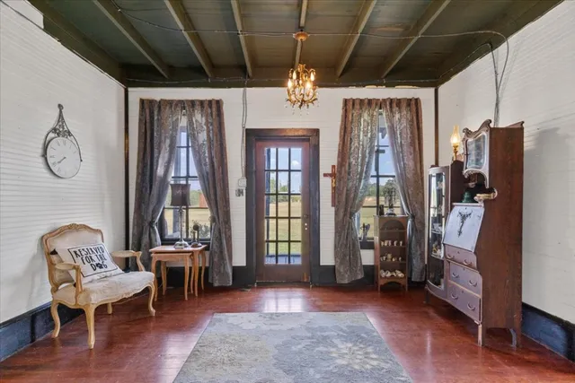 a view of hall way with furniture and chandelier