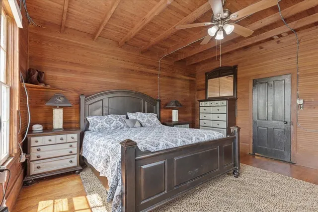 a bedroom with a bed and a dresser
