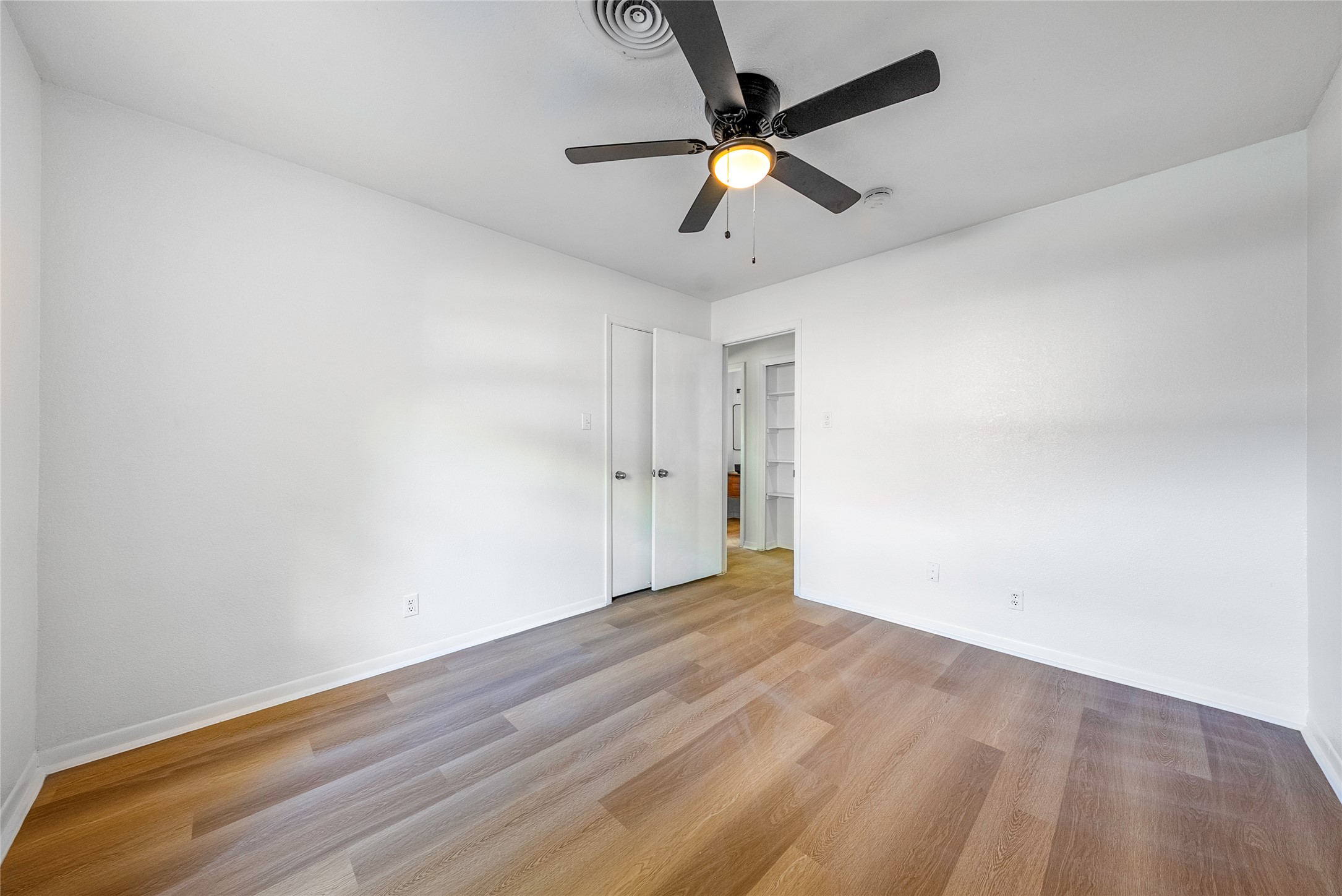 807 Country Club Road Georgetown, TX 78628 - Photo 22 of 28 an empty room with wooden floor and windows
