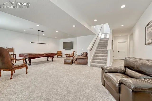 a living room with furniture and stairs