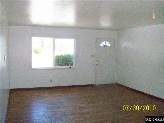 1650 Dayton Way Reno, NV 89502 - Photo 2 of 9 an empty room with wooden floor and windows