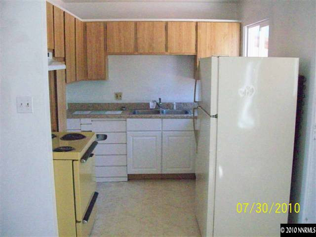 1650 Dayton Way Reno, NV 89502 - Photo 3 of 9 a kitchen with a refrigerator a stove a sink and cabinets