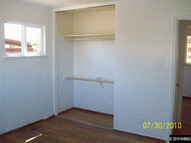 1650 Dayton Way Reno, NV 89502 - Photo 5 of 9 a view of an empty room with wooden floor and a window