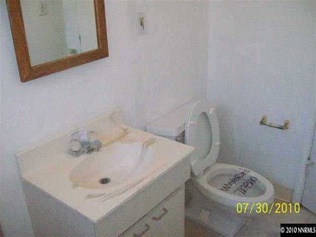 1650 Dayton Way Reno, NV 89502 - Photo 7 of 9 a bathroom with a sink a toilet and mirror