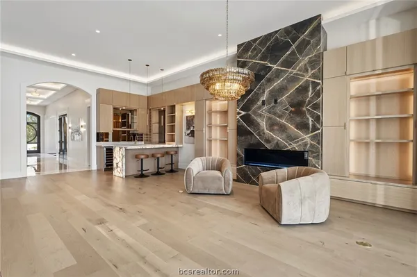 a view of a kitchen with furniture and wooden floor