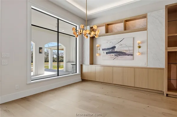 a kitchen with a sink cabinets and wooden floor